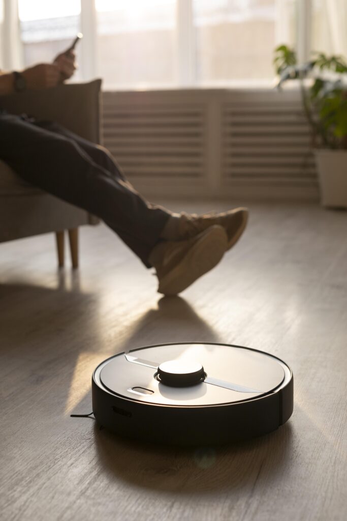 man-using-robot-vacuum-living-room